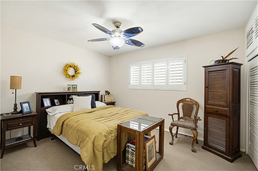 1090 Fourth Street Norco, CA 92860 - Photo 13 of 21 a bedroom with a bed and a chandelier
