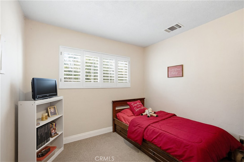 1090 Fourth Street Norco, CA 92860 - Photo 14 of 21 a bedroom with a bed and a flat screen tv