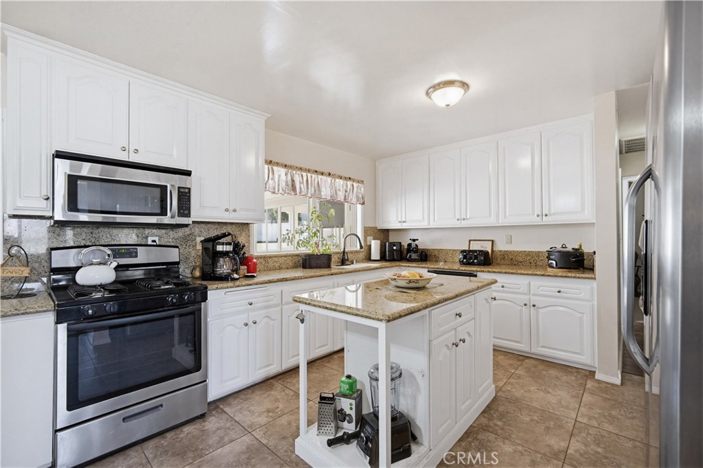 1090 Fourth Street Norco, CA 92860 - Photo 3 of 21 a kitchen with cabinets appliances a sink and a window