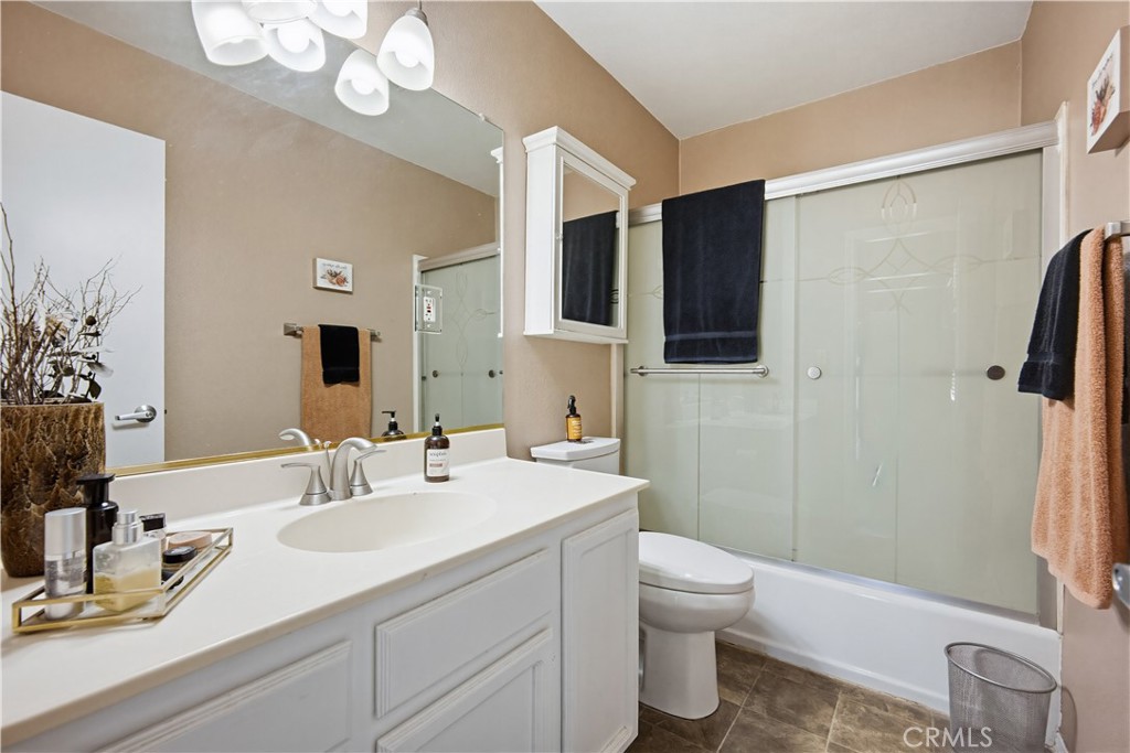 1090 Fourth Street Norco, CA 92860 - Photo 9 of 21 a bathroom with a sink a toilet and shower a mirror