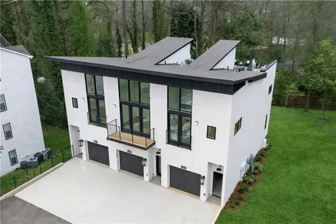 a view of a white house with a sink and backyard
