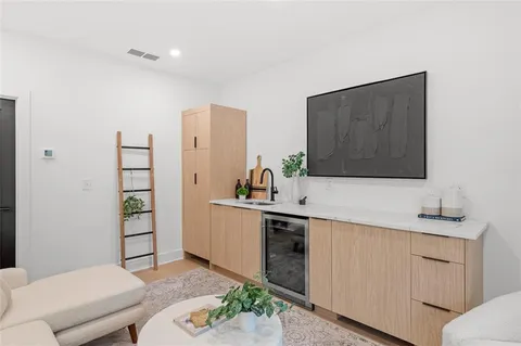 a kitchen with a sink and a mirror