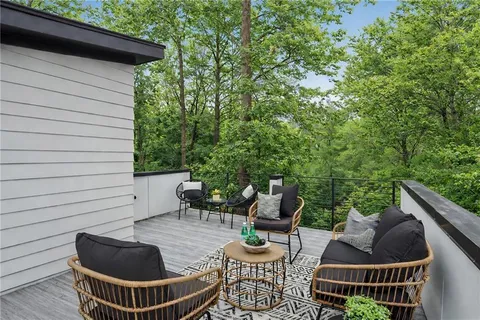 a view of patio with couches table and chairs and potted plants