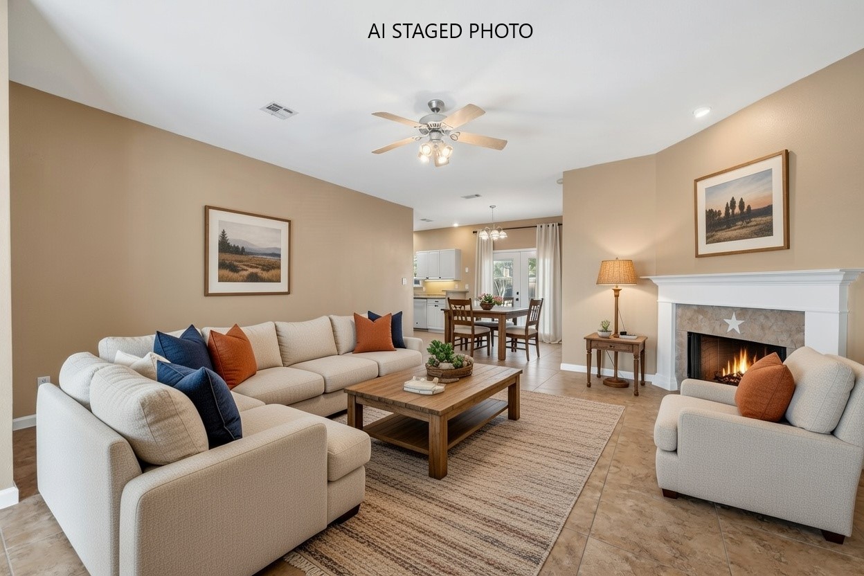 Living area featuring a tiled fireplace, a ceiling fan, and light tile patterned floors