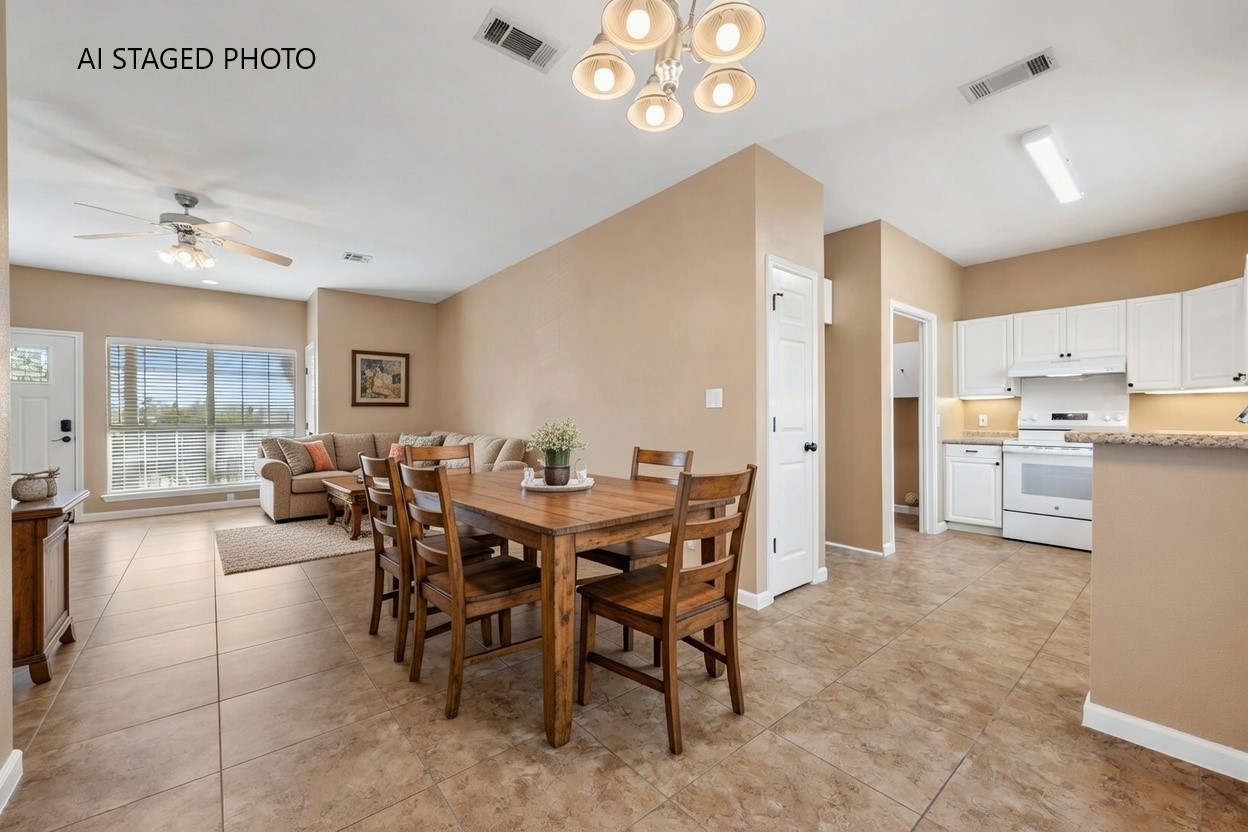 3139 Chisholm Trail Austin, TX 78734 - Photo 16 of 37 Dining space featuring a ceiling fan, light tile patterned floors, and suspended lighting