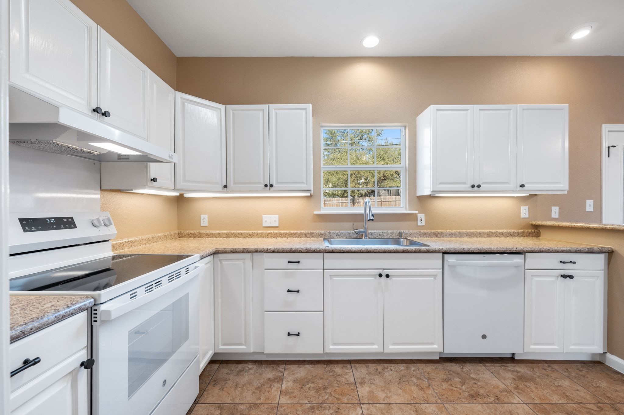 3139 Chisholm Trail Austin, TX 78734 - Photo 19 of 37 Kitchen with white appliances and white cabinets