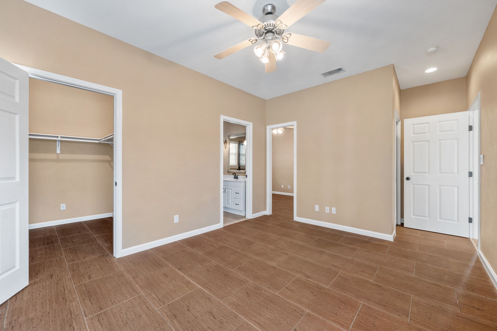 3139 Chisholm Trail Austin, TX 78734 - Photo 25 of 37 Unfurnished bedroom featuring a spacious closet, recessed lighting, a ceiling fan, and connected bathroom