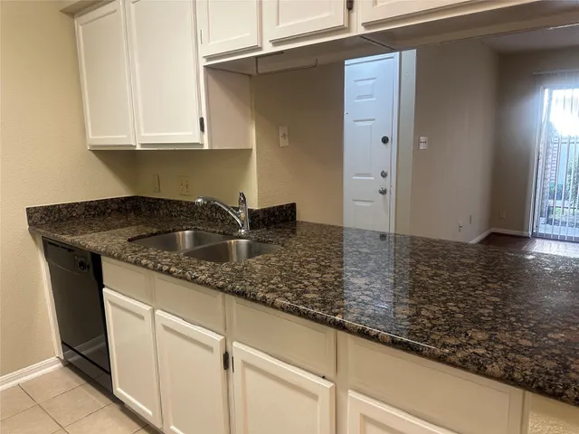 a kitchen with sink and cabinets