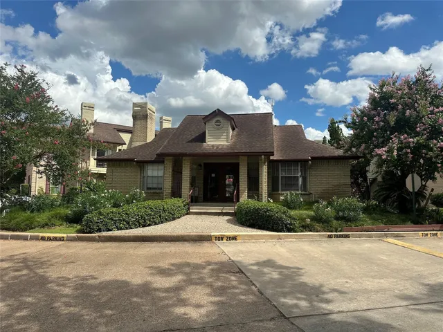 a view of a tennis ground with large trees