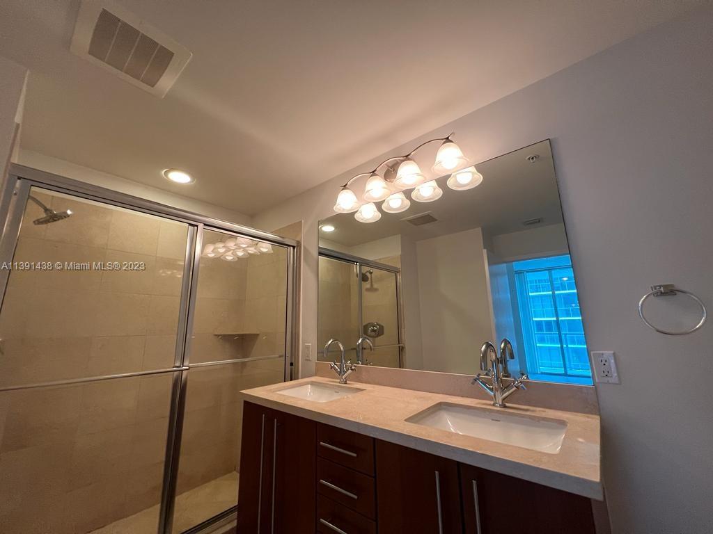 1111 Southwest 1st Avenue, Unit 2316N Miami, FL 33130 - Photo 14 of 37 a bathroom with a sink double vanity and a mirror