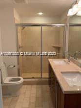 1111 Southwest 1st Avenue, Unit 2316N Miami, FL 33130 - Photo 17 of 37 a bathroom with a sink a toilet and a mirror