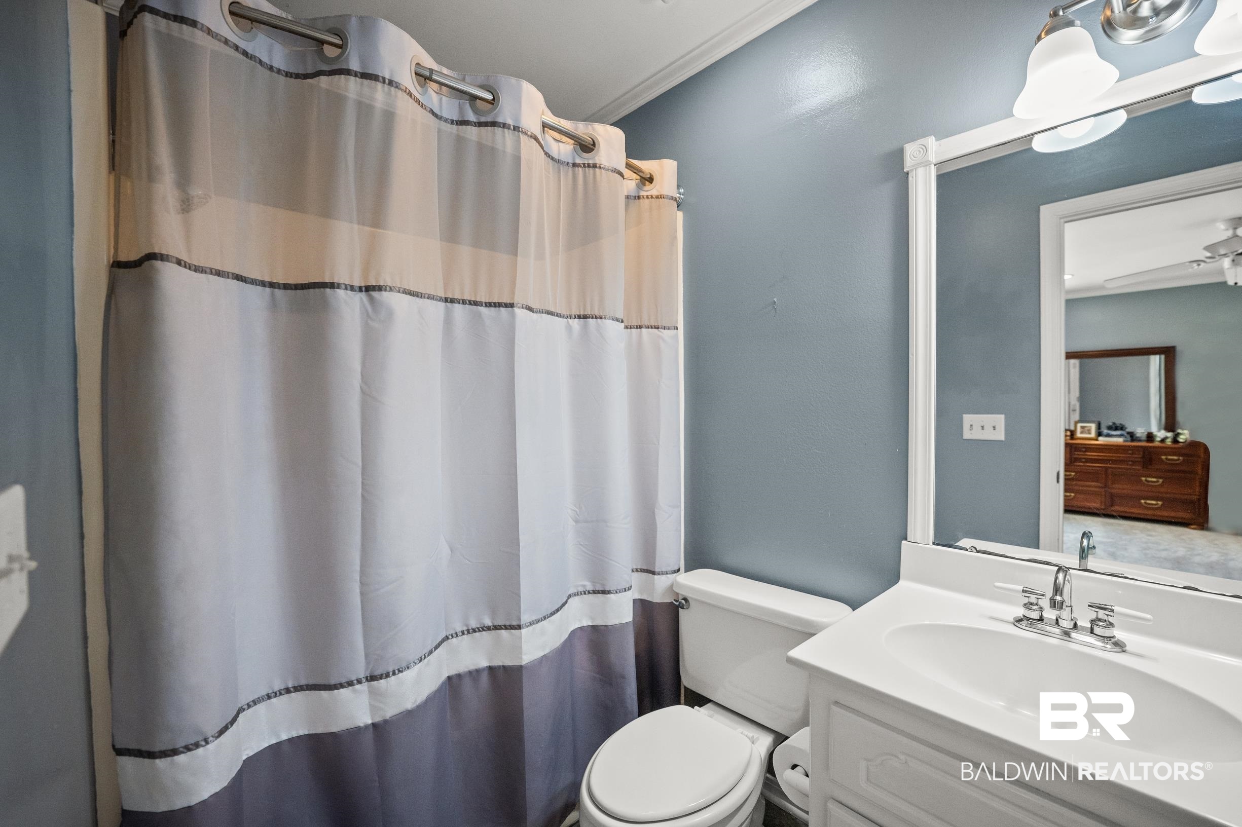 196 Morning Ridge Road Monroeville, AL 36460 - Photo 55 of 71 Bathroom featuring vanity, ornamental molding, and curtained shower
