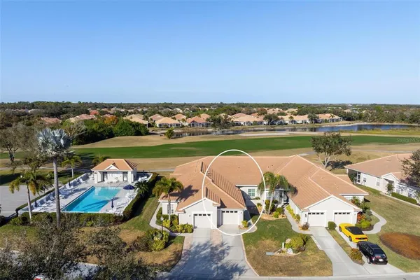 an aerial view of a house with a lake view
