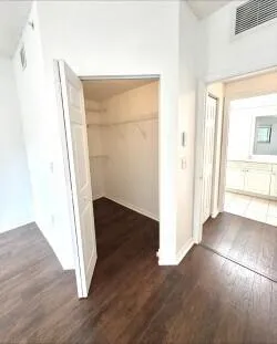 a view of a hallway with wooden floor