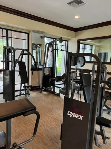 a kitchen with stainless steel appliances dining table a window and chairs