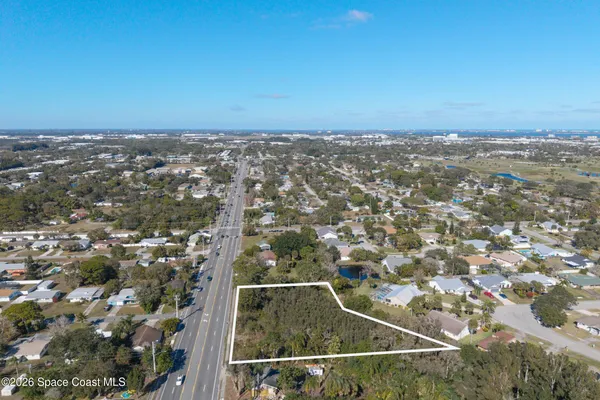 an aerial view of house with yard