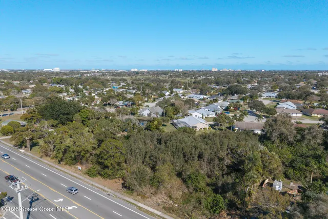 an aerial view of residential houses with city view