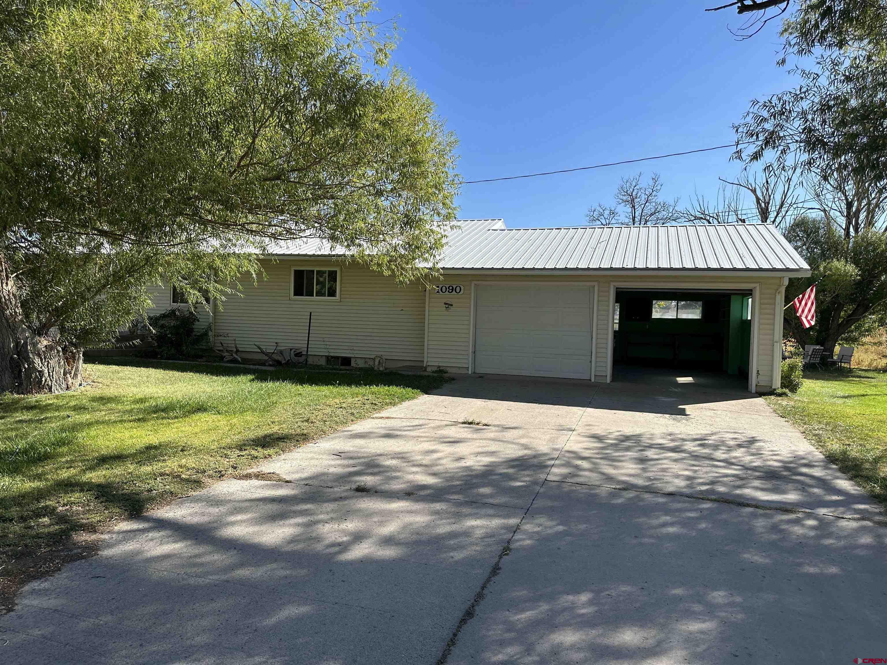 1090 Cloverleaf Lane Delta, CO 81416 - Photo 1 of 30 a front view of a house with a yard and garage