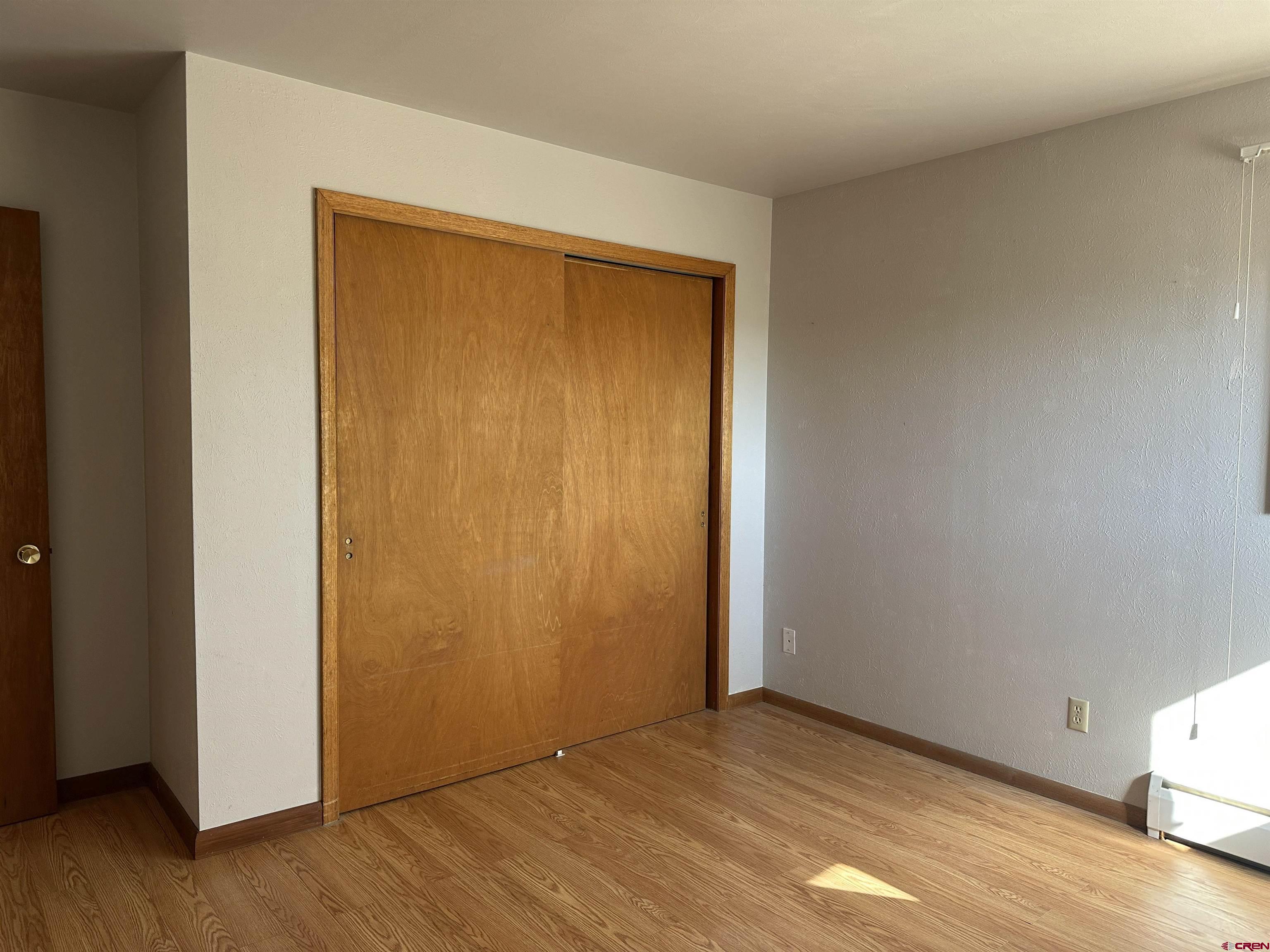 1090 Cloverleaf Lane Delta, CO 81416 - Photo 11 of 30 a view of an empty room with wooden floor