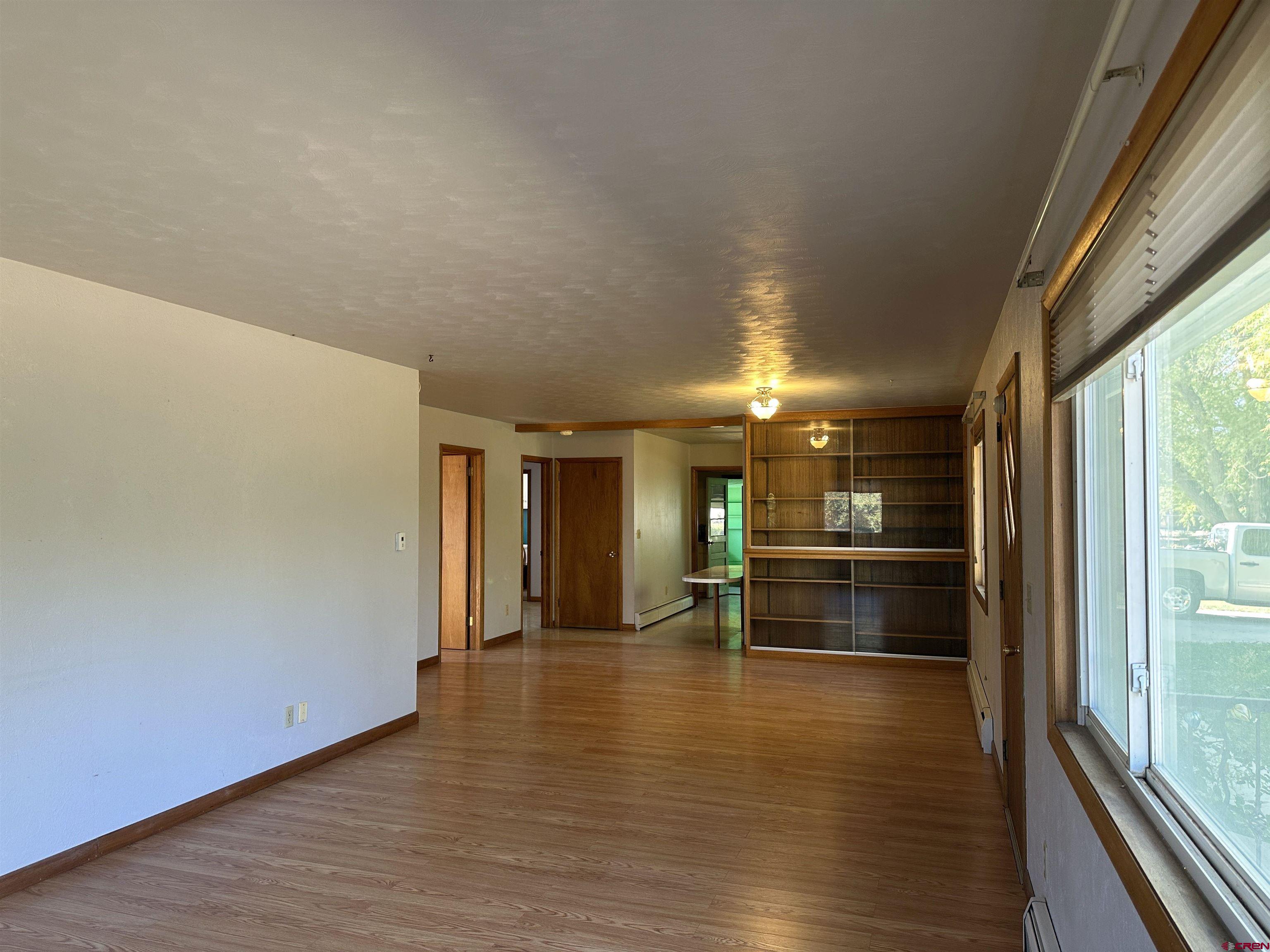 1090 Cloverleaf Lane Delta, CO 81416 - Photo 15 of 30 a hallway with wooden floor and chandelier