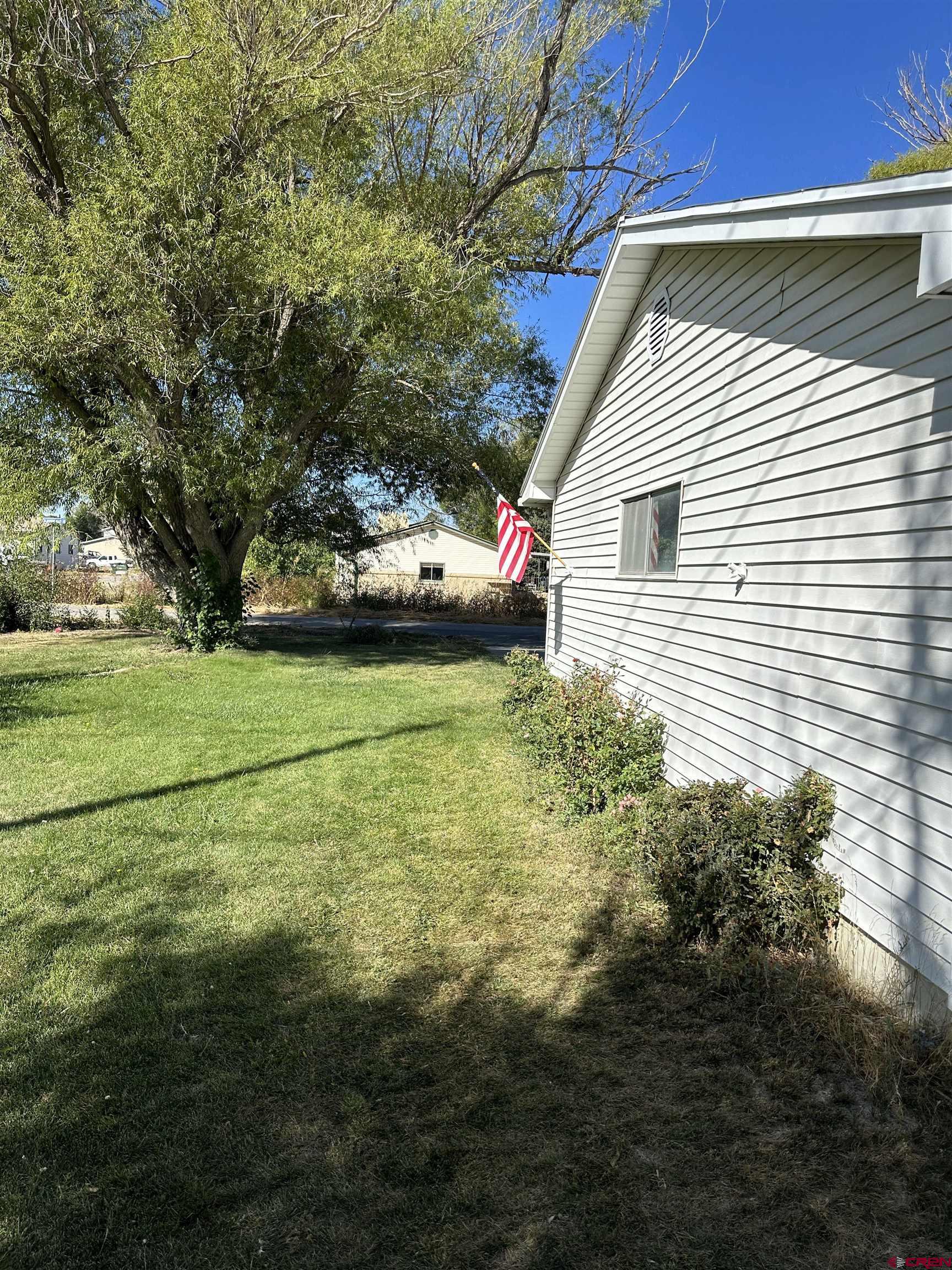 1090 Cloverleaf Lane Delta, CO 81416 - Photo 25 of 30 a view of a house with a yard