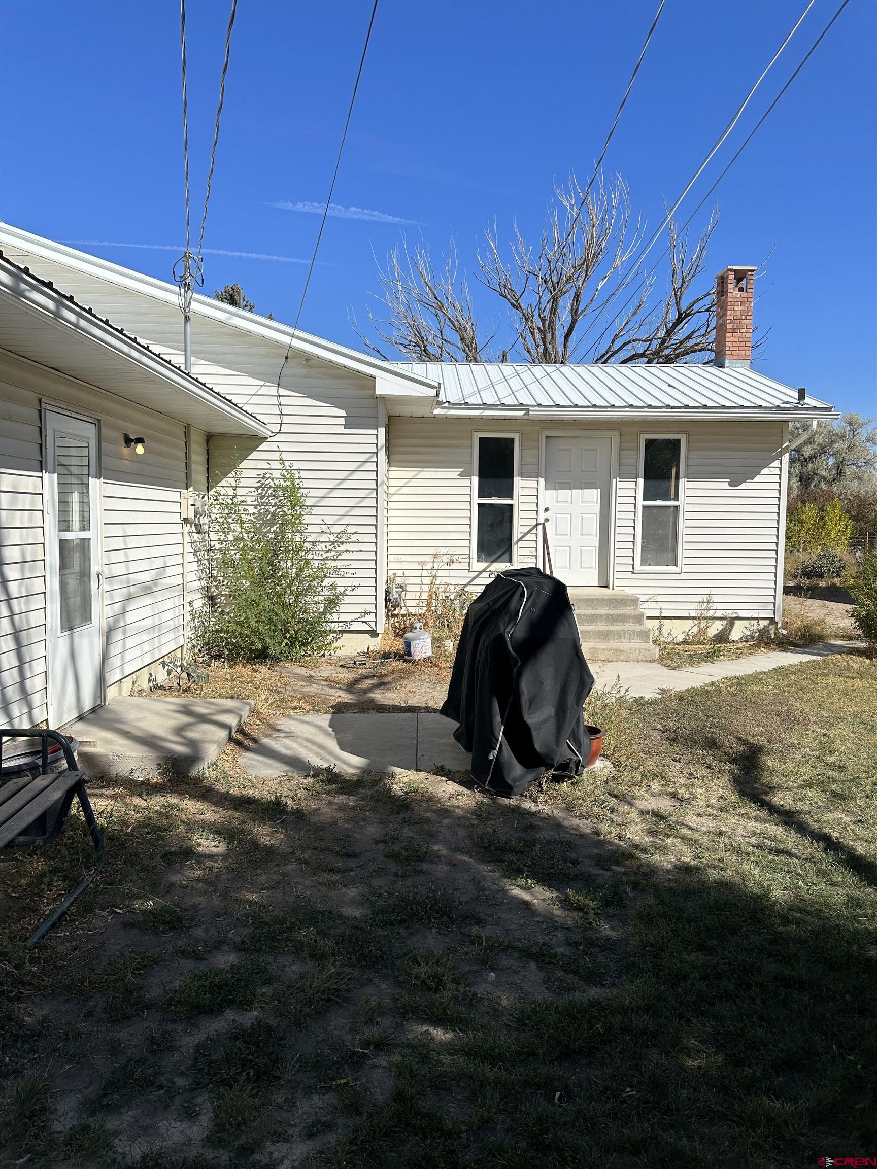 1090 Cloverleaf Lane Delta, CO 81416 - Photo 26 of 30 a view of a house with backyard and trees