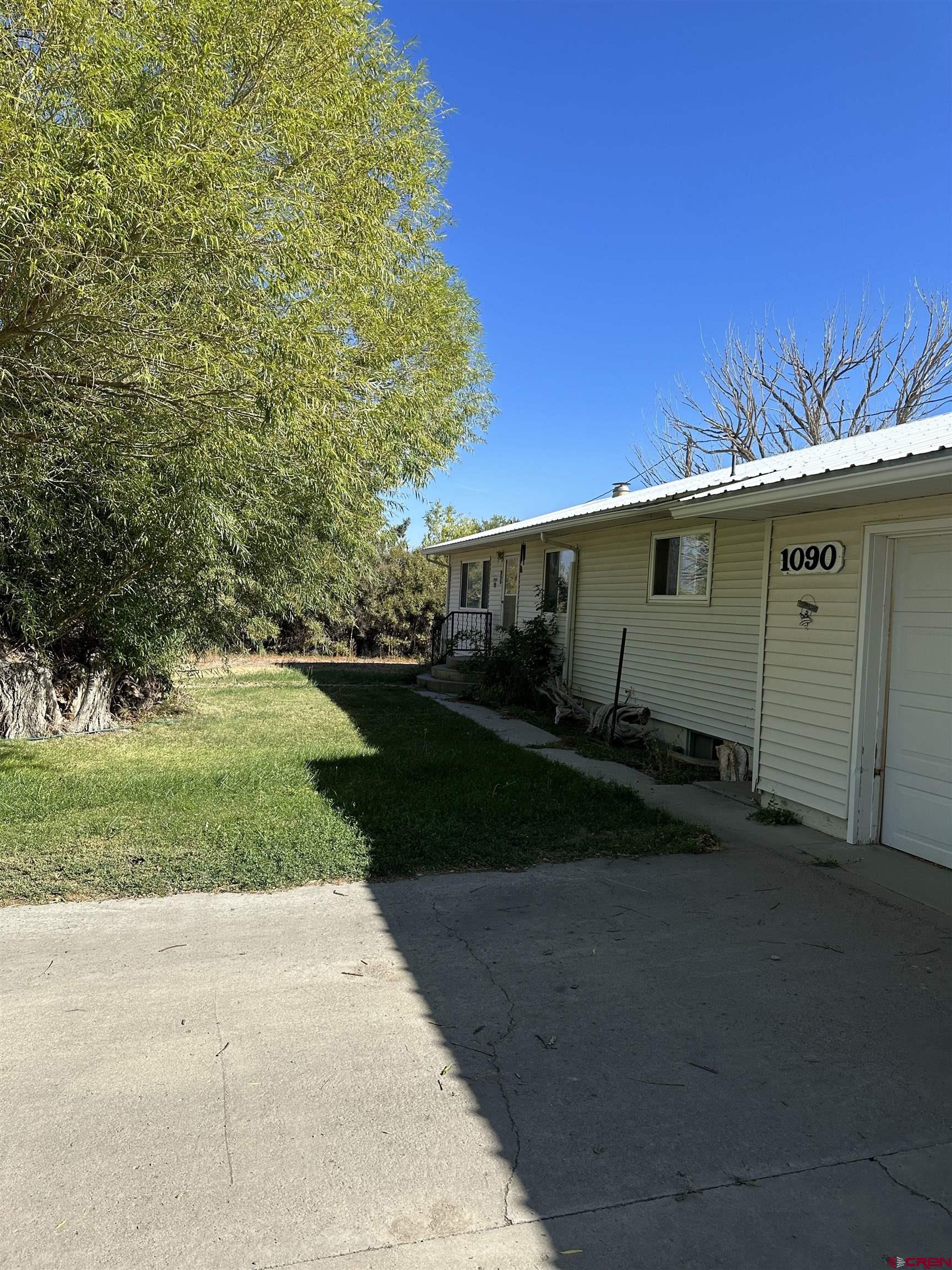 1090 Cloverleaf Lane Delta, CO 81416 - Photo 27 of 30 a front view of a house with a yard