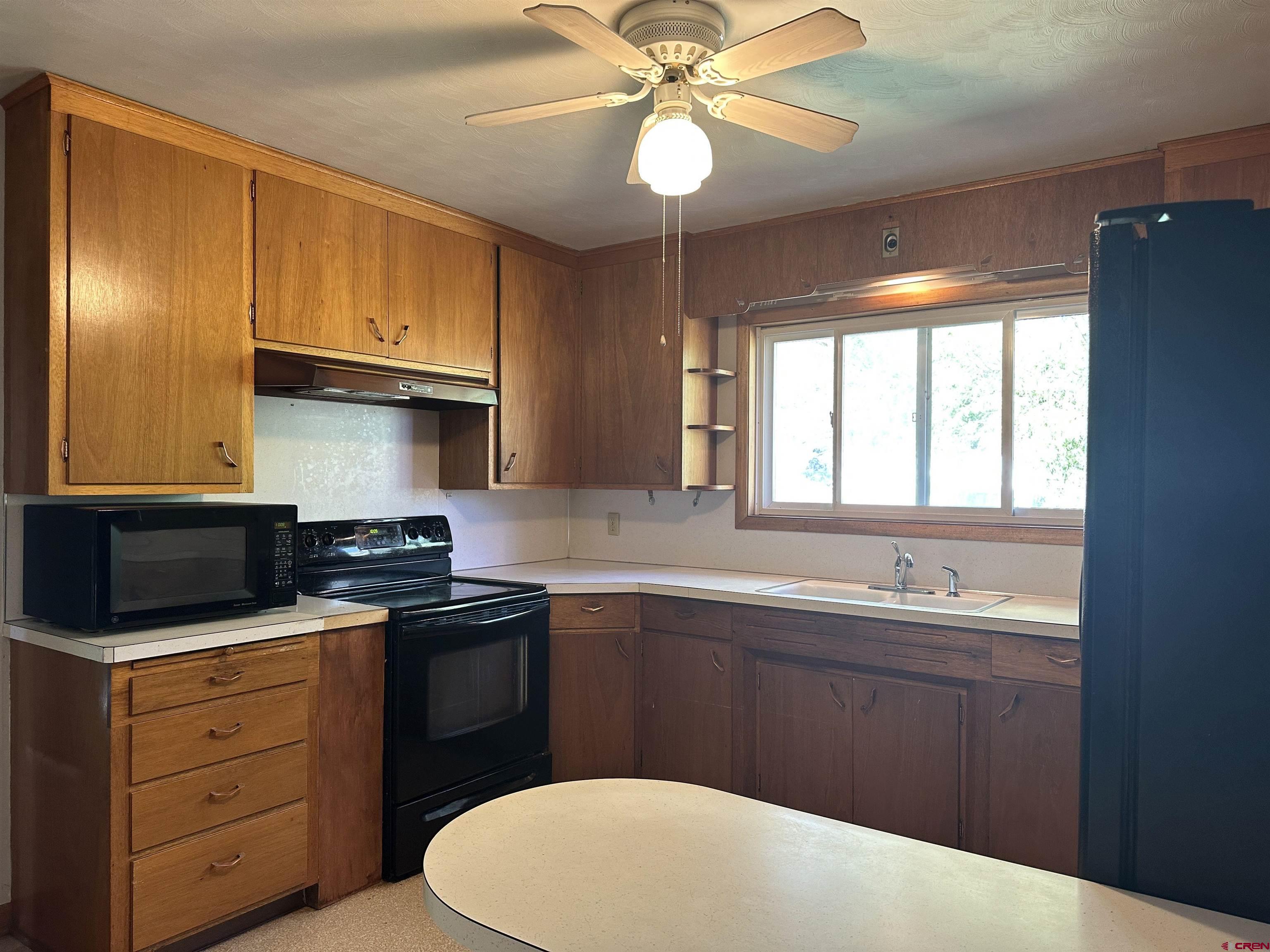 1090 Cloverleaf Lane Delta, CO 81416 - Photo 5 of 30 a kitchen with a sink stove and cabinets