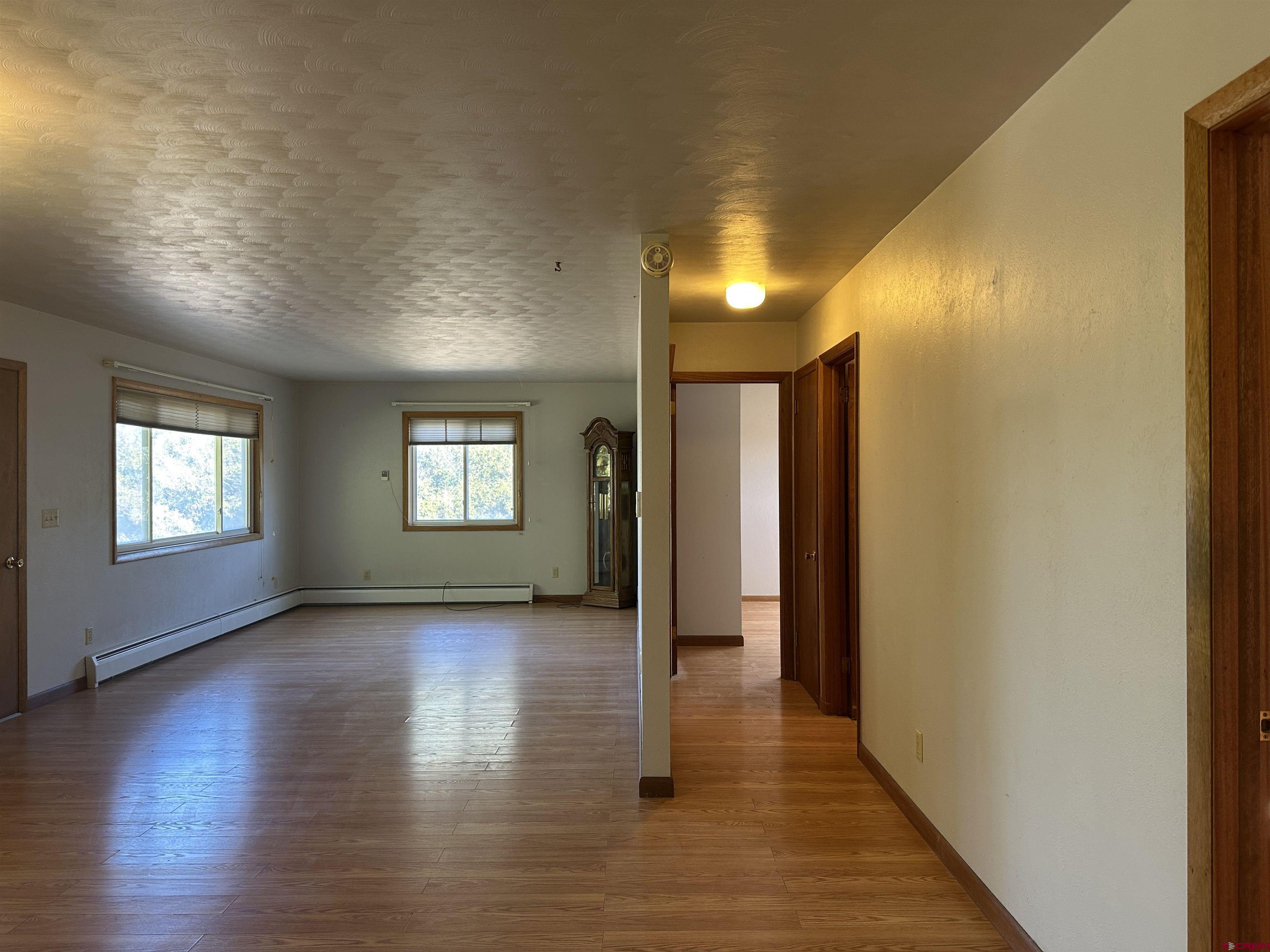 1090 Cloverleaf Lane Delta, CO 81416 - Photo 7 of 30 an empty room with wooden floor and windows