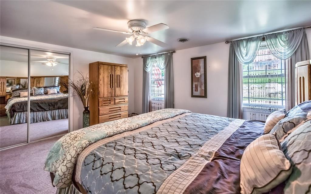 1524 Anderson Road Pittsburgh, PA 15209 - Photo 11 of 25 a bedroom with a large bed and a chandelier