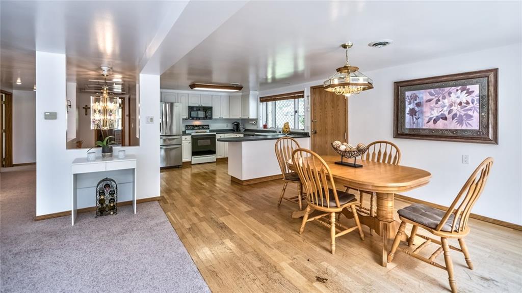 1524 Anderson Road Pittsburgh, PA 15209 - Photo 9 of 25 a view of a dining room with furniture a chandelier and wooden floor