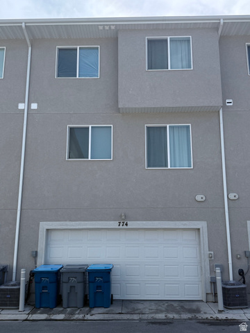 774 West 480 South American Fork, UT 84003 - Photo 4 of 76 Multi-story stucco exterior with white window frames and a two-car garage