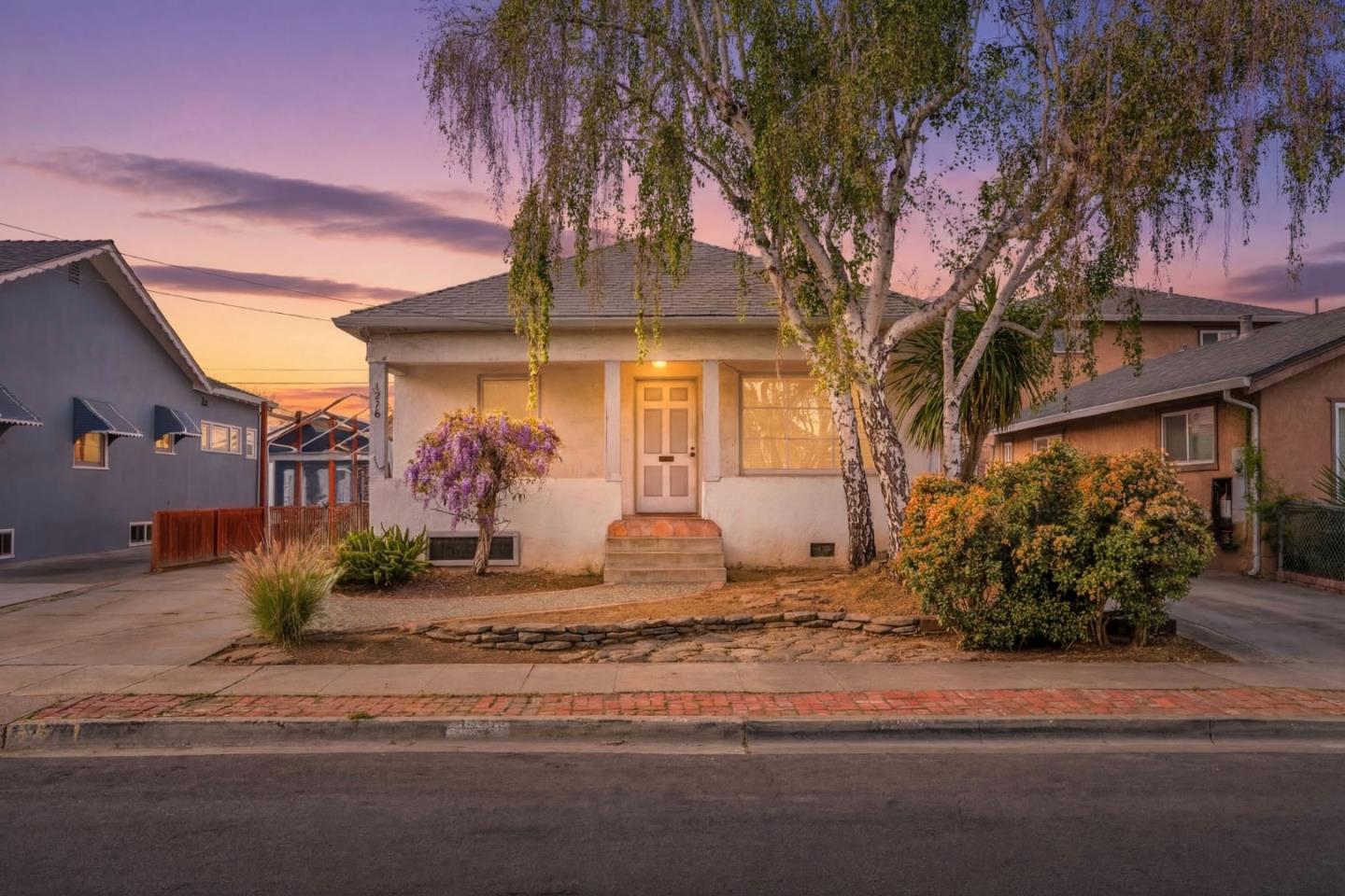 a front view of a house with garden