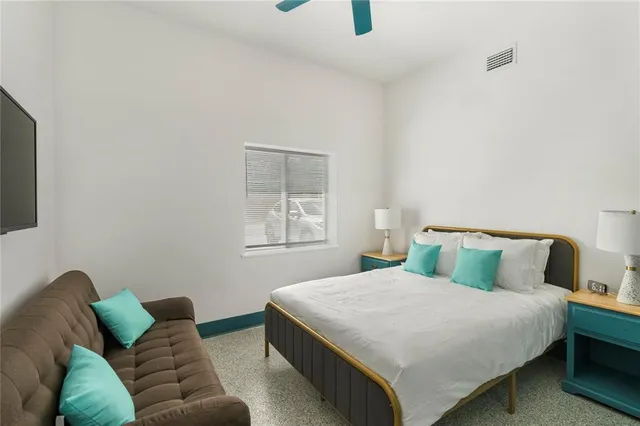 a bedroom with a bed and a window