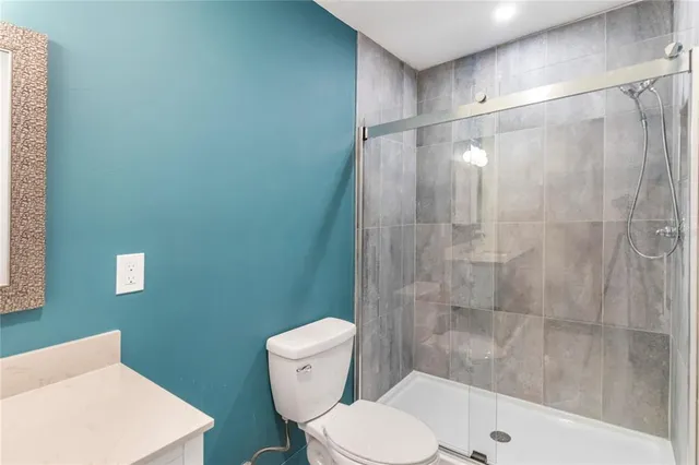 a bathroom with a toilet and shower