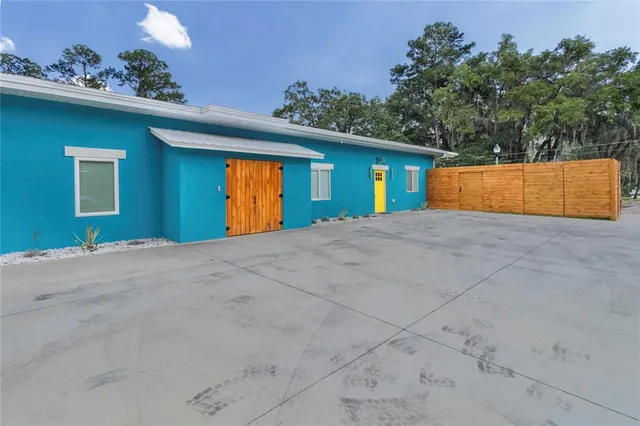 a view of a house with a garage and yard