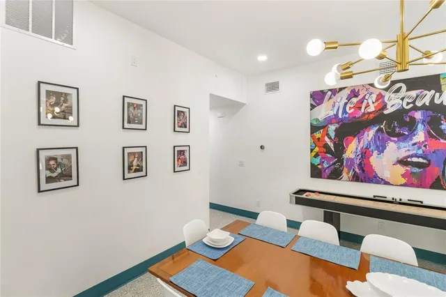 a room with furniture and wall paintings