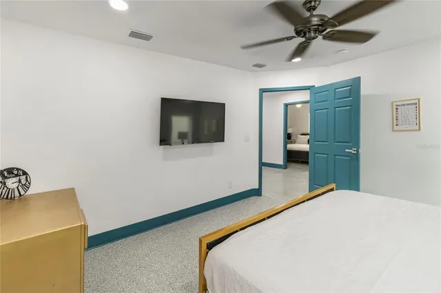 a bedroom with a bed and a flat screen tv