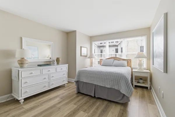 a kitchen with stainless steel appliances granite countertop a sink a stove a refrigerator cabinets and a dining table