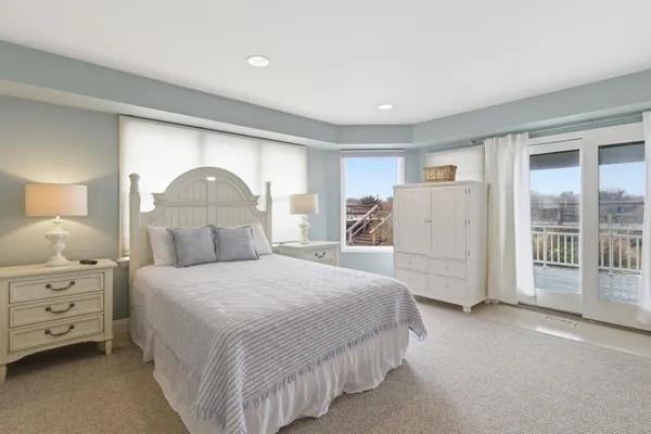 a bedroom with a bed wooden floor and window
