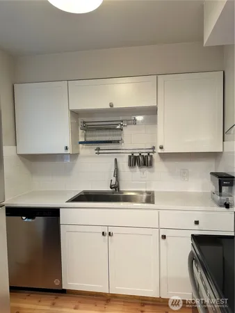 a kitchen with a sink cabinets and appliances