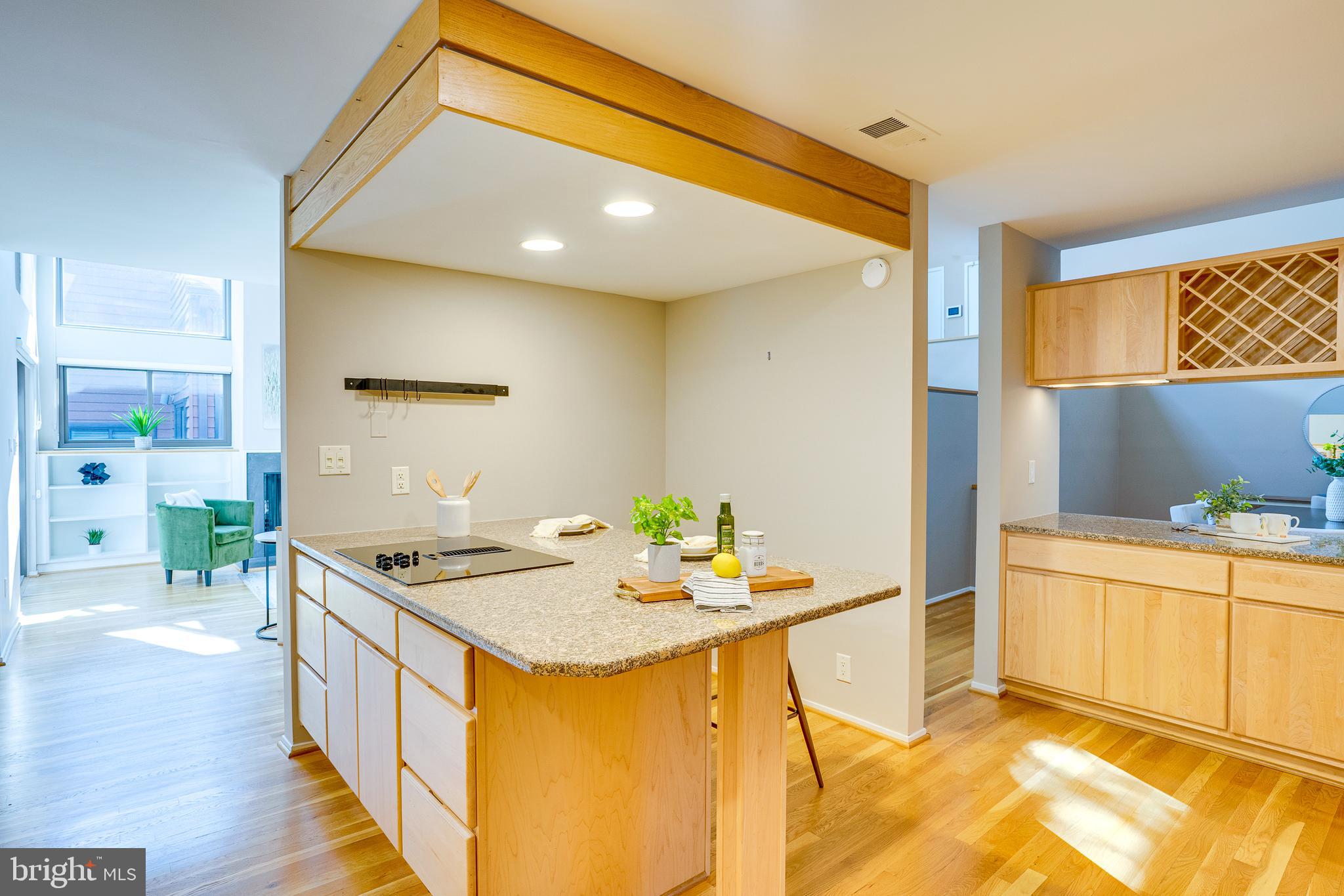 2148 South Bay Lane Reston, VA 20191 - Photo 34 of 73 a kitchen with stainless steel appliances kitchen island granite countertop a sink and cabinets