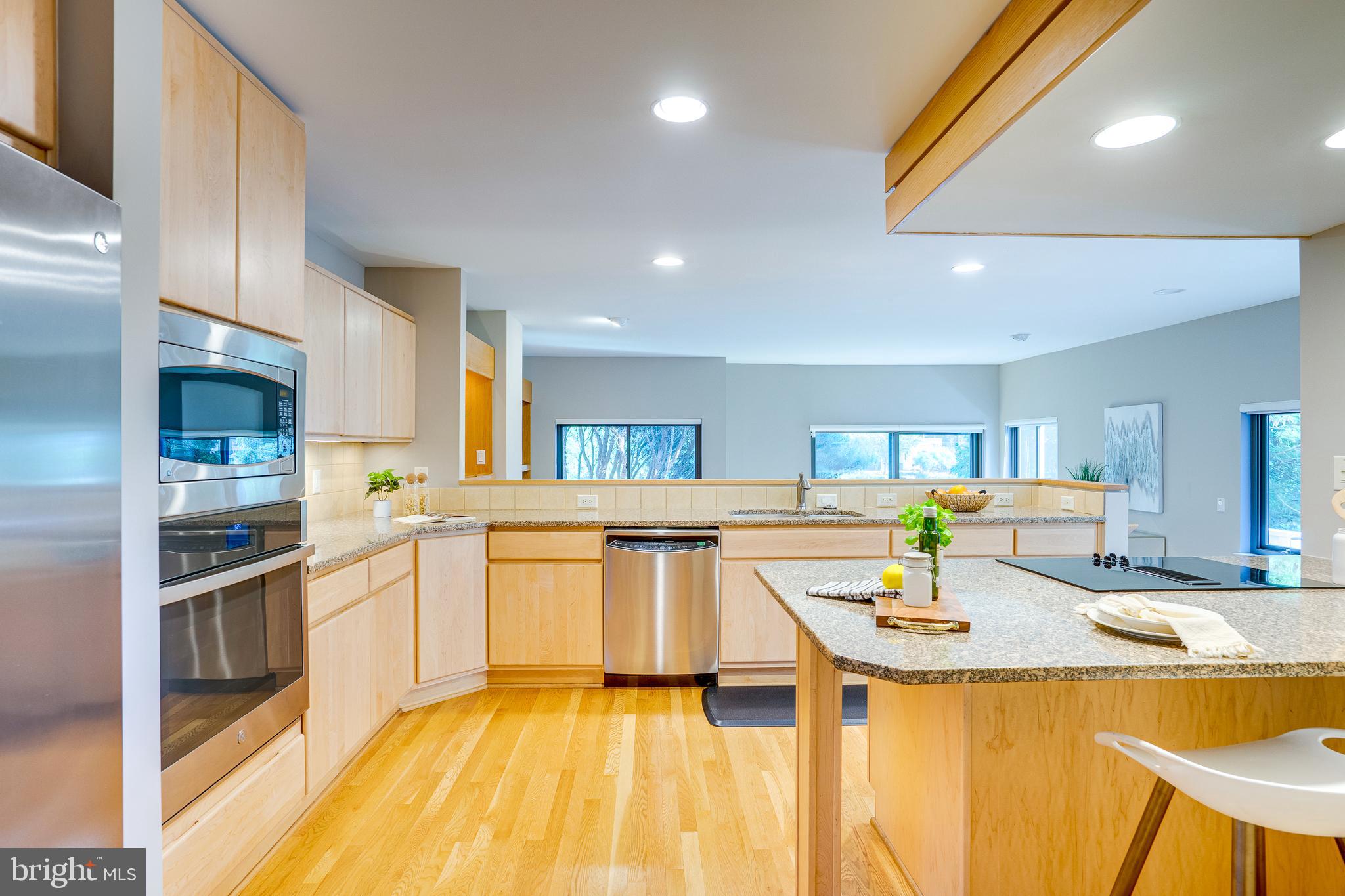 2148 South Bay Lane Reston, VA 20191 - Photo 35 of 73 a kitchen with stainless steel appliances granite countertop a sink and counter space