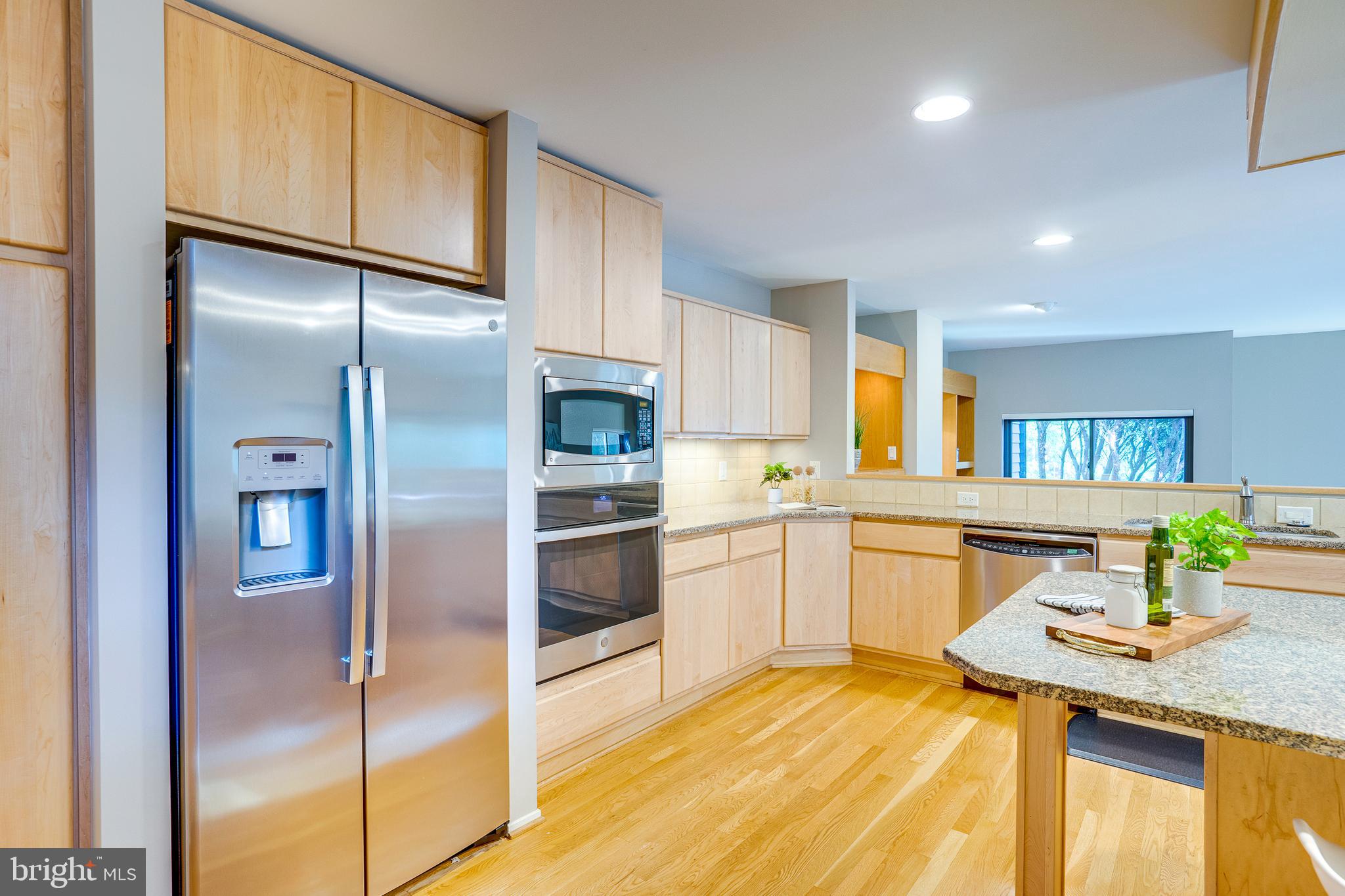 2148 South Bay Lane Reston, VA 20191 - Photo 36 of 73 a kitchen with stainless steel appliances granite countertop a refrigerator and a sink