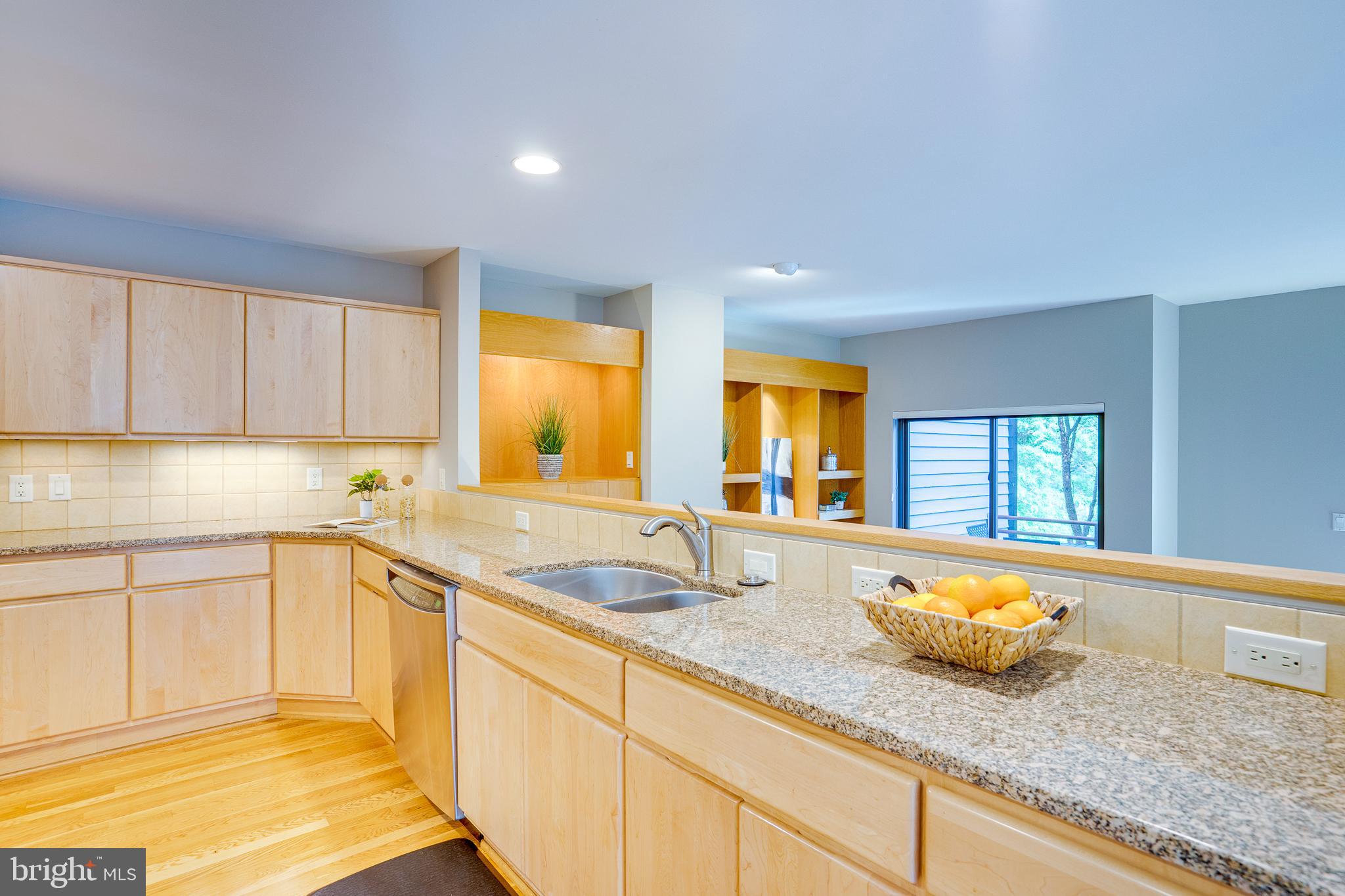 2148 South Bay Lane Reston, VA 20191 - Photo 38 of 73 a kitchen with granite countertop sink and cabinets