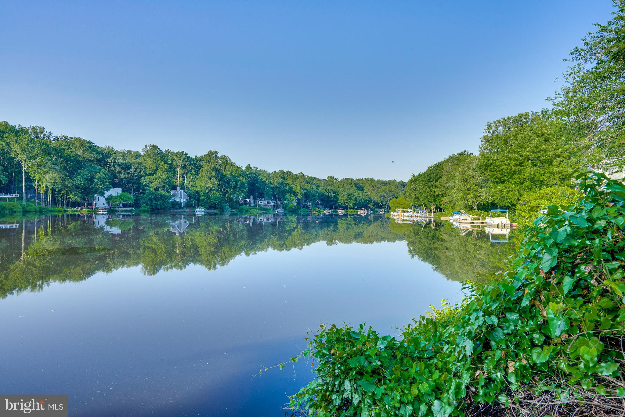 2148 South Bay Lane Reston, VA 20191 - Photo 5 of 73 a view of a lake with a house in the background
