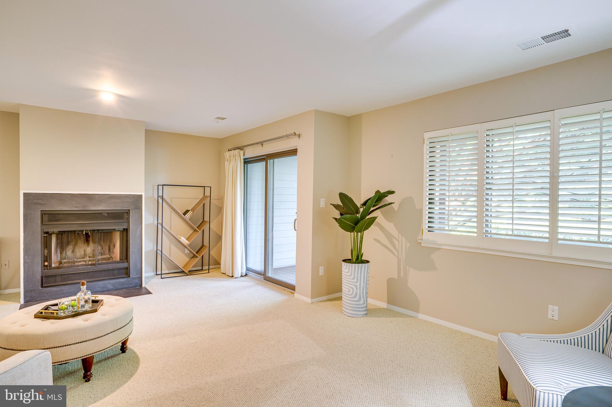 2148 South Bay Lane Reston, VA 20191 - Photo 51 of 73 a living room with furniture a window and a fireplace