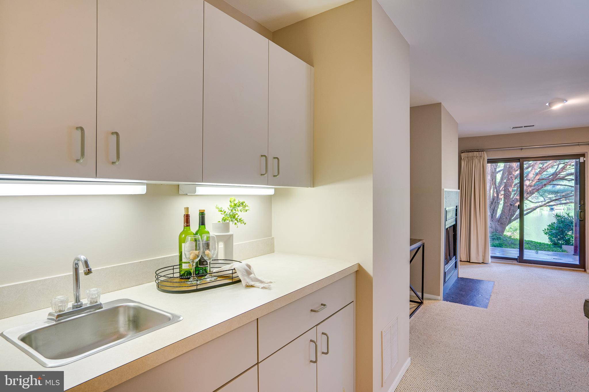 2148 South Bay Lane Reston, VA 20191 - Photo 54 of 73 a kitchen with stainless steel appliances granite countertop a sink a granite counter tops and a view of living room