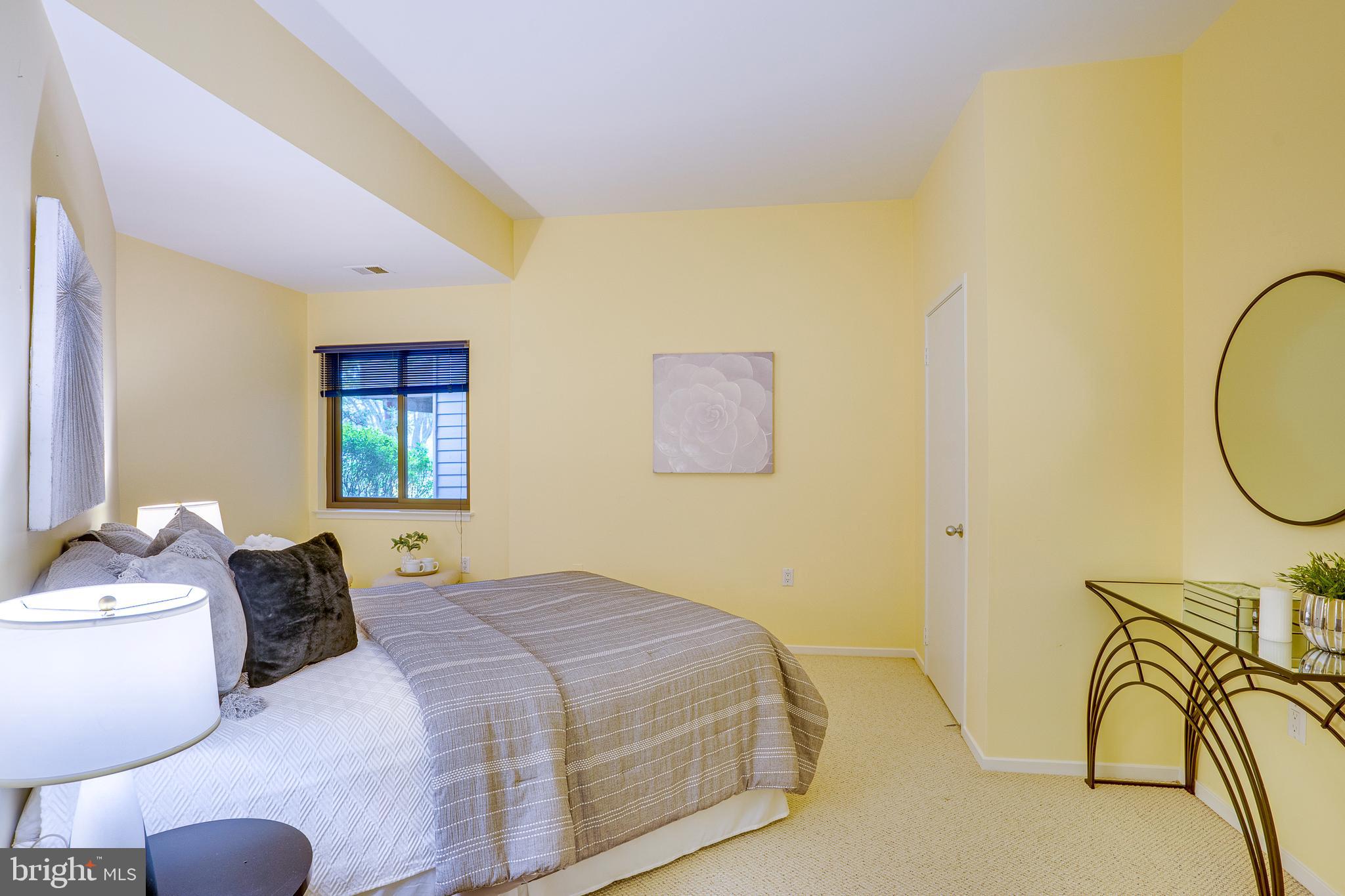 2148 South Bay Lane Reston, VA 20191 - Photo 59 of 73 a bedroom with a bed dresser and a window