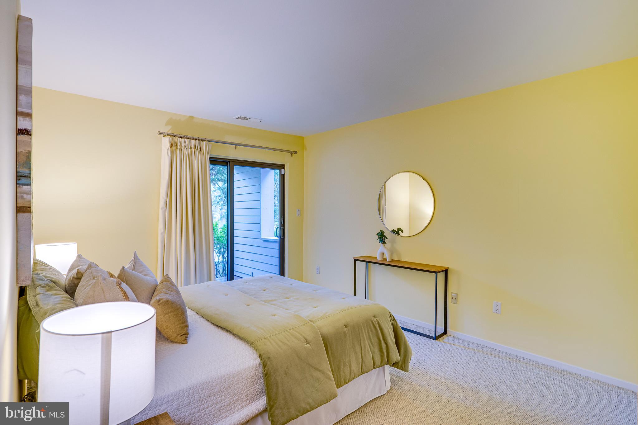 2148 South Bay Lane Reston, VA 20191 - Photo 63 of 73 a bedroom with a bed and a lamp on dresser